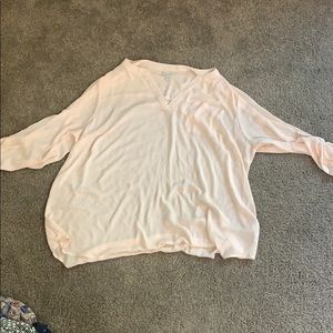 We have a peach tone long sleeve blouse
